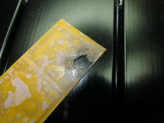 Big hole in the thermal tape caused by the arc